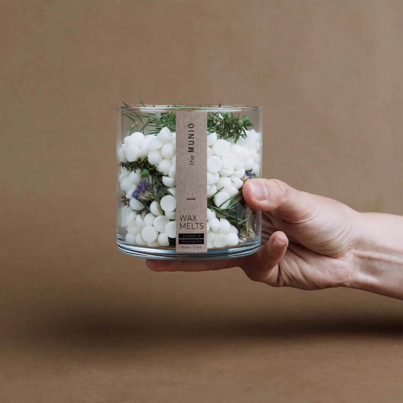 Juniper & limonium soy wax melts in a glass votive